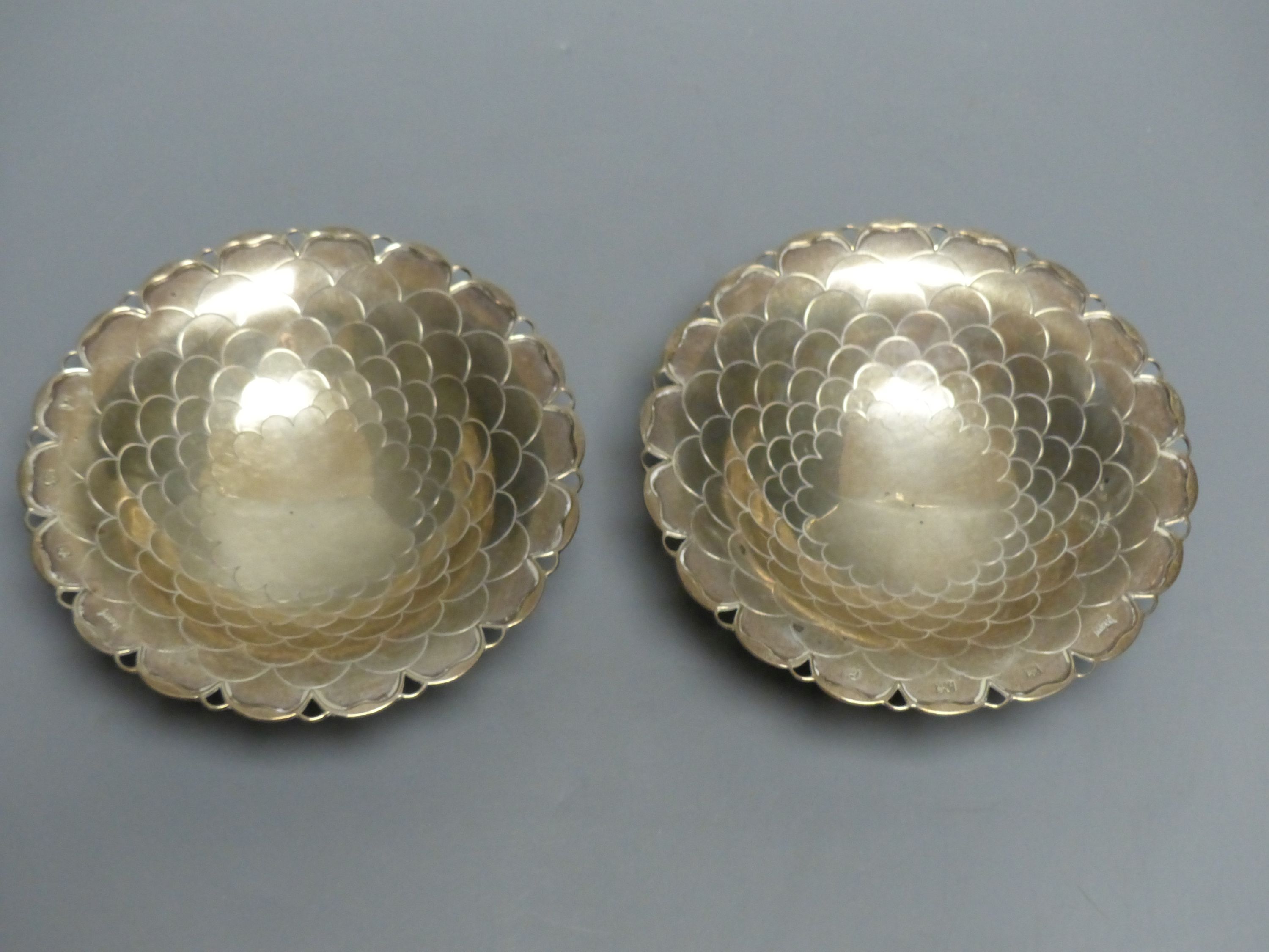 A pair of circular silver sweetmeat tazzas each having scale decoration, shaped rim and circular foot, Sheffield 1957, 15.4cm,